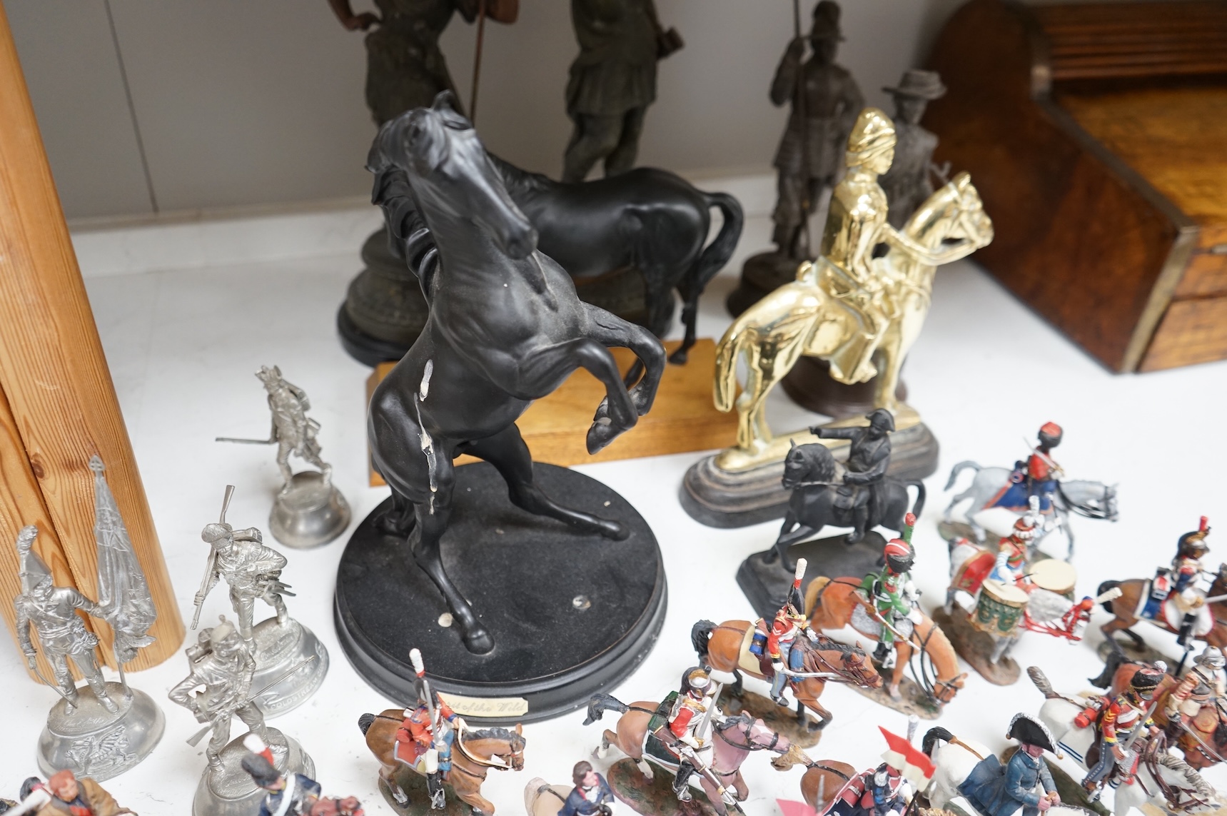 A pair of spelter figures a brass door stop two models of horses two other figures and a large group of toy soldiers. Tallest 45cm.